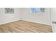 Bedroom with wood-look floors, white walls, art and bright window at 2559 Winterwood Blvd, Las Vegas, NV 89142