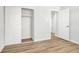 Bedroom with wood floors features a closet with white sliding doors at 2559 Winterwood Blvd, Las Vegas, NV 89142