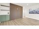 Bright living room with light wood floors, modern wall decor, and view into the kitchen space at 2559 Winterwood Blvd, Las Vegas, NV 89142