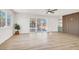 Open living room with light wood floors, plenty of natural light, sliding doors, and modern accents at 2559 Winterwood Blvd, Las Vegas, NV 89142