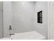 Stylish shower with marble-look tile, a built-in niche, and modern fixtures at 2559 Winterwood Blvd, Las Vegas, NV 89142