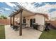 Inviting backyard features a covered patio with outdoor seating and barbecue area at 2860 Galena Peak Ln, Las Vegas, NV 89156