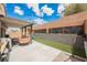 Landscaped backyard features brick retaining wall and covered patio area at 2860 Galena Peak Ln, Las Vegas, NV 89156