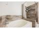 Bathroom featuring a soaking tub and tiled shower with a neutral color scheme at 2860 Galena Peak Ln, Las Vegas, NV 89156