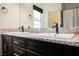 Bathroom featuring double sinks with granite counters and dark wood cabinets at 2860 Galena Peak Ln, Las Vegas, NV 89156
