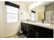 Bathroom showcasing double vanity with granite counters and natural light at 2860 Galena Peak Ln, Las Vegas, NV 89156