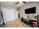 Spacious bedroom with wood floors, closet, and a TV at 2860 Galena Peak Ln, Las Vegas, NV 89156