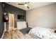 Modern bedroom features wood floors, a ceiling fan, and a TV at 2860 Galena Peak Ln, Las Vegas, NV 89156
