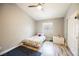 Bright bedroom features a ceiling fan, wood floors, and a window for natural light at 2860 Galena Peak Ln, Las Vegas, NV 89156