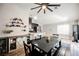 Open dining area featuring a modern ceiling fan, stylish built-in cabinet, and wood-style flooring at 2860 Galena Peak Ln, Las Vegas, NV 89156