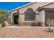 Close up of front door and window with decorative stone and desert landscaping at 2860 Galena Peak Ln, Las Vegas, NV 89156