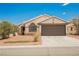 Exterior view of home featuring well maintained desert landscaping with a two car garage at 2860 Galena Peak Ln, Las Vegas, NV 89156