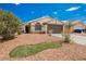 View of the home showing desert landscaping and the two-car garage at 2860 Galena Peak Ln, Las Vegas, NV 89156