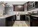 Open kitchen design featuring stainless steel appliances, dark wood cabinets and a granite countertop island at 2860 Galena Peak Ln, Las Vegas, NV 89156