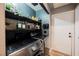 Laundry room features built-in shelves above modern washer and dryer units at 2860 Galena Peak Ln, Las Vegas, NV 89156