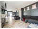 Spacious living room with wood-look floors, stone fireplace, and neutral decor at 2860 Galena Peak Ln, Las Vegas, NV 89156