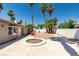 Spacious backyard featuring a concrete patio, fire pit, desert landscaping, and a seating area, perfect for relaxing outdoors at 3143 La Mesa Dr, Henderson, NV 89014