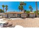 View of the home's backyard with desert landscaping, fire pit, and patio set at 3143 La Mesa Dr, Henderson, NV 89014