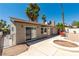 Property backyard with desert landscaping, concrete patio, and sliders to the home's interior at 3143 La Mesa Dr, Henderson, NV 89014