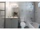 Bathroom with tiled shower-tub, white vanity, mirror, and storage for bath items at 3143 La Mesa Dr, Henderson, NV 89014