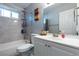 Bathroom featuring tiled shower-tub combo, white vanity, and a stylish mirror at 3143 La Mesa Dr, Henderson, NV 89014