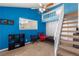 Unique bedroom features blue accent wall, loft, stairs, and closet at 3143 La Mesa Dr, Henderson, NV 89014