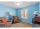 Carpeted bedroom with a window featuring two comfy chairs and a side table with lamps at 3143 La Mesa Dr, Henderson, NV 89014