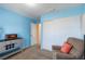 Blue bedroom featuring comfortable seating, a closet, and a vintage radio cabinet at 3143 La Mesa Dr, Henderson, NV 89014