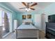 Cozy bedroom with a ceiling fan and sliding glass door to the backyard at 3143 La Mesa Dr, Henderson, NV 89014