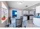 Cozy dining area features a bay window, neutral paint, and view into kitchen with white cabinets at 3143 La Mesa Dr, Henderson, NV 89014