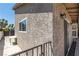 Exterior of a home with a window, stucco wall, and covered patio area at 3143 La Mesa Dr, Henderson, NV 89014
