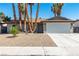 Charming single-story home with a two-car garage and desert landscaping at 3143 La Mesa Dr, Henderson, NV 89014