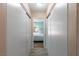 Hallway with sliding closet doors looking through to a bedroom with backyard access at 3143 La Mesa Dr, Henderson, NV 89014