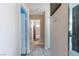 Hallway leading to a bathroom showcasing neutral tones and tile flooring throughout the home at 3143 La Mesa Dr, Henderson, NV 89014