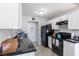 The kitchen features white cabinets and black appliances at 3143 La Mesa Dr, Henderson, NV 89014