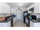 Bright kitchen featuring white cabinets, black appliances, and ample counter space at 3143 La Mesa Dr, Henderson, NV 89014