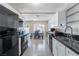 Bright kitchen features white cabinets, black appliances, and tile flooring at 3143 La Mesa Dr, Henderson, NV 89014
