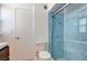 Well-lit bathroom featuring a blue tiled shower with glass door at 3368 Seneca Dr, Las Vegas, NV 89169