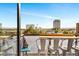 Cozy balcony seating area with views of the city skyline and blue skies at 353 E Bonneville Ave # 555, Las Vegas, NV 89101