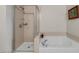 A bathroom featuring a tub and separate tiled shower with glass doors at 353 E Bonneville Ave # 555, Las Vegas, NV 89101
