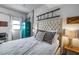 Bedroom with tufted headboard, concrete accent wall, and unique decorative ladder at 353 E Bonneville Ave # 555, Las Vegas, NV 89101