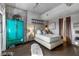 Comfortable bedroom with a tufted headboard, vibrant storage, and concrete-look accent wall at 353 E Bonneville Ave # 555, Las Vegas, NV 89101