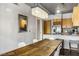 Dining room view adjacent to kitchen with modern light fixture and seating for six at 353 E Bonneville Ave # 555, Las Vegas, NV 89101