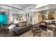 Open-concept living area with modern furniture, integrated kitchen, and concrete-look elements at 353 E Bonneville Ave # 555, Las Vegas, NV 89101