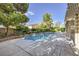 This backyard boasts mature trees, lush landscaping, a pool, and an in-ground spa at 386 Wiseton Ave, Las Vegas, NV 89183