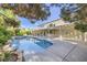 The backyard features a pool, spa, covered patio, lush landscaping, and an exterior view of the house at 386 Wiseton Ave, Las Vegas, NV 89183