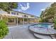 A beautiful backyard features a patio, large inground spa, lush landscaping, and a large pool at 386 Wiseton Ave, Las Vegas, NV 89183