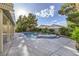 This backyard features a pool, an in-ground spa, a patio, and lush landscaping at 386 Wiseton Ave, Las Vegas, NV 89183
