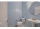 Powder room featuring blue walls, pedestal sink and a toilet at 386 Wiseton Ave, Las Vegas, NV 89183