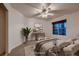 Calm bedroom featuring a ceiling fan, comfortable bed, and a view of the outside, creating a relaxing ambiance at 386 Wiseton Ave, Las Vegas, NV 89183